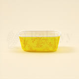Yellow decorative container with floral patterns on a beige background