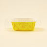 Yellow decorative container with floral patterns on a beige background