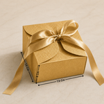 Gold gift box with a bow and measurements on a beige background