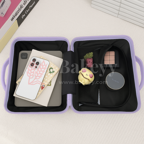 Open purple case containing a phone, notebook, and small decorative items on a light background.
