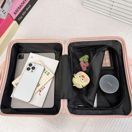 Pink travel case with compartments containing a phone, books, and other items on a light surface.