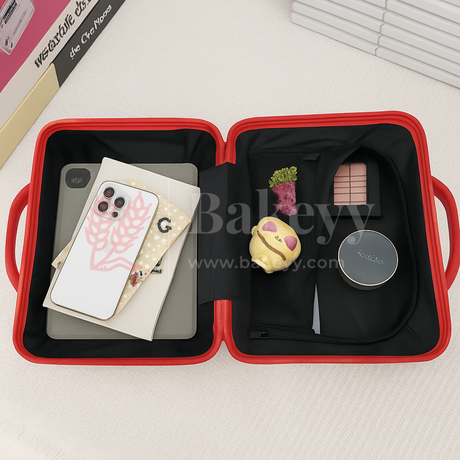 Red carrying case with phone, cards, and small decorative items on a light background