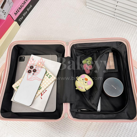 Pink travel case with phone, books, and other items on a light background