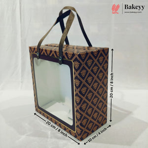 A rectangular bakery gift box with a clear front window and two handles, shown with dimension arrows and labels indicating 20 cm by 20 cm by 10 cm.