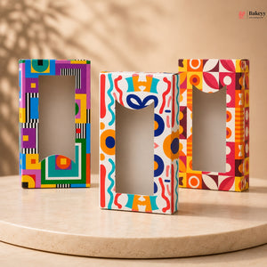Three colorful letter-shaped boxes on a wooden surface with a beige background