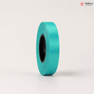 Roll of teal ribbon on a light beige background