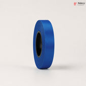 Roll of blue ribbon on a light gray background
