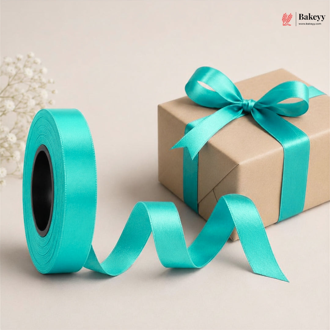 Turquoise ribbon spool and wrapped gift box with a bow on a beige background, featuring the Bakey brand.