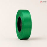 Roll of green ribbon on a beige background with 'Bakeyy' branding.