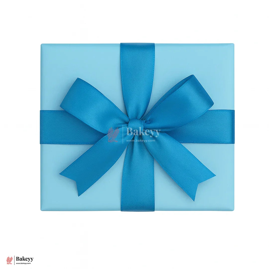 Blue gift box with a large blue bow on a white background