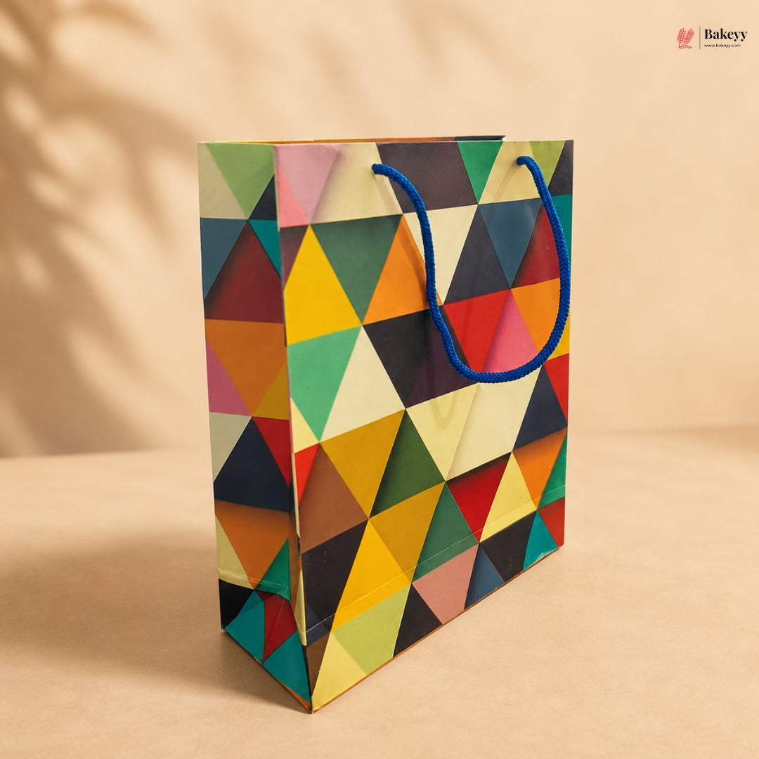 Colorful geometric-patterned paper bag with a blue handle on a beige background
