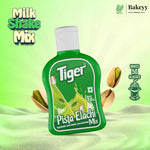 Green bottle of Tiger Pista Elachi Mix on a green background with 'Bakeyy' branding.