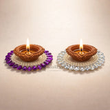 Decorative clay diyas with beads on Bakeyy.com, ideal for festive or gift decorations.