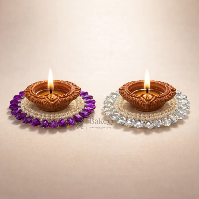 Decorative clay diyas with beads on Bakeyy.com, ideal for festive or gift decorations.