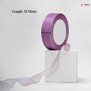 Roll of purple ribbon with a white box on a light gray background, featuring Bakeey branding.