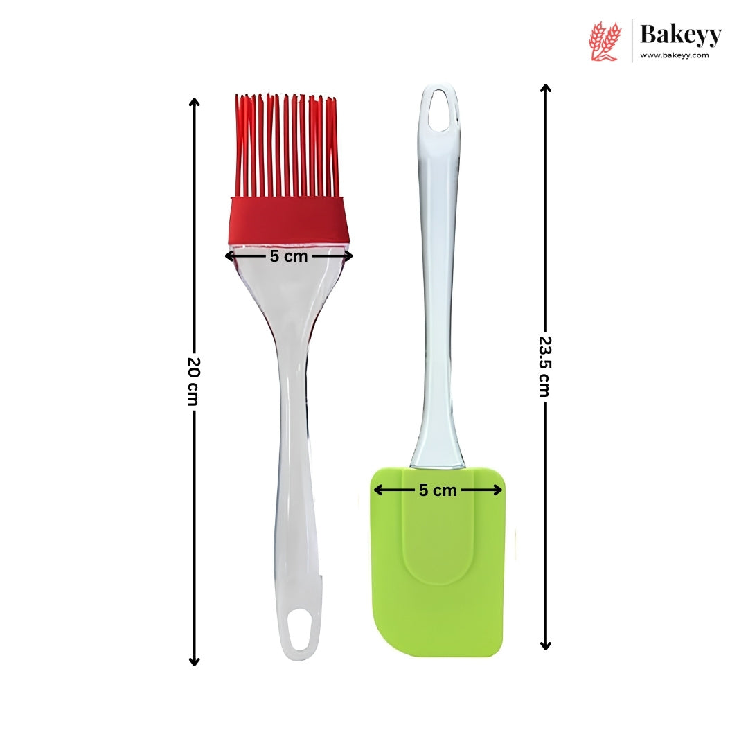 Two baking utensils on a white background with dimension arrows and labels: a silicone pastry brush with red bristles and a white handle, and a green silicone spatula with a white handle. Black arrows show measurements of 20 cm, 23.