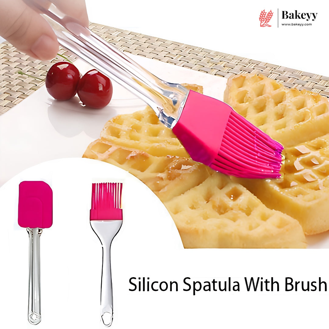 A silicone pastry brush with a bright pink silicone head and clear handle is shown being used to brush waffles with syrup. The image includes a circular inset showing the brush alone from two angles, with cherries and a woven placemat in the background.