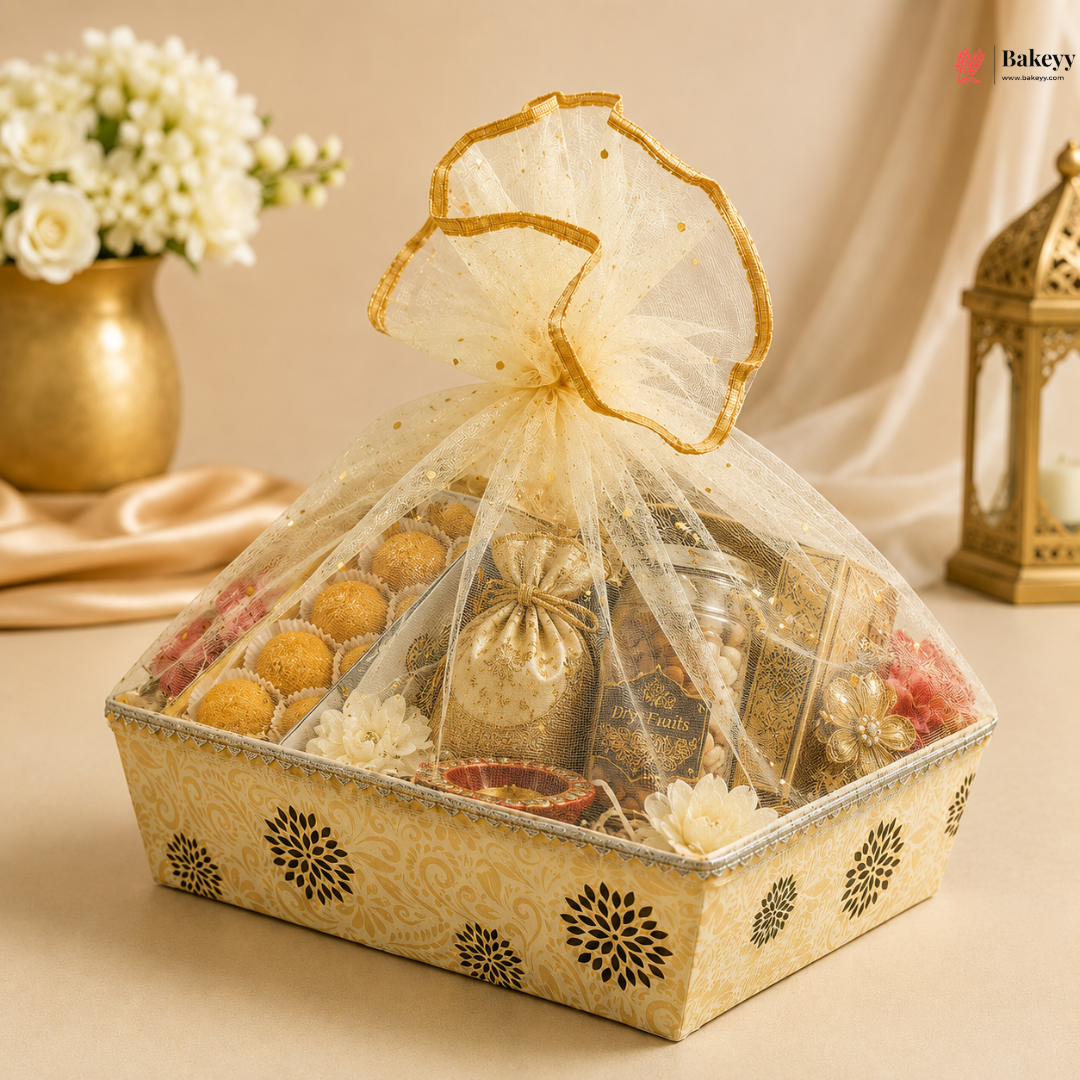 Decorative gift box with a bow, containing various items, on a beige background.
