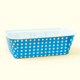 Blue container with white polka dots on a beige background
