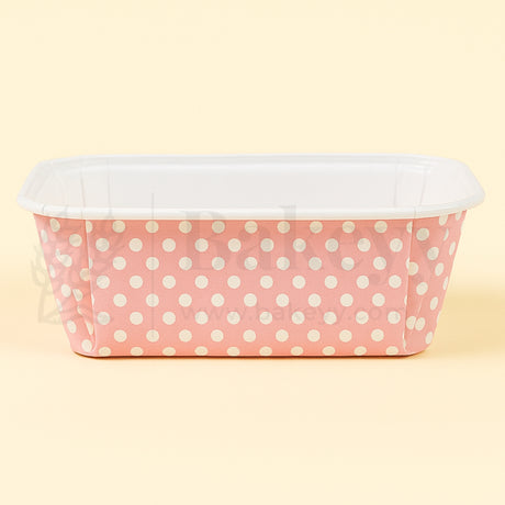 Pink container with white polka dots on a beige background
