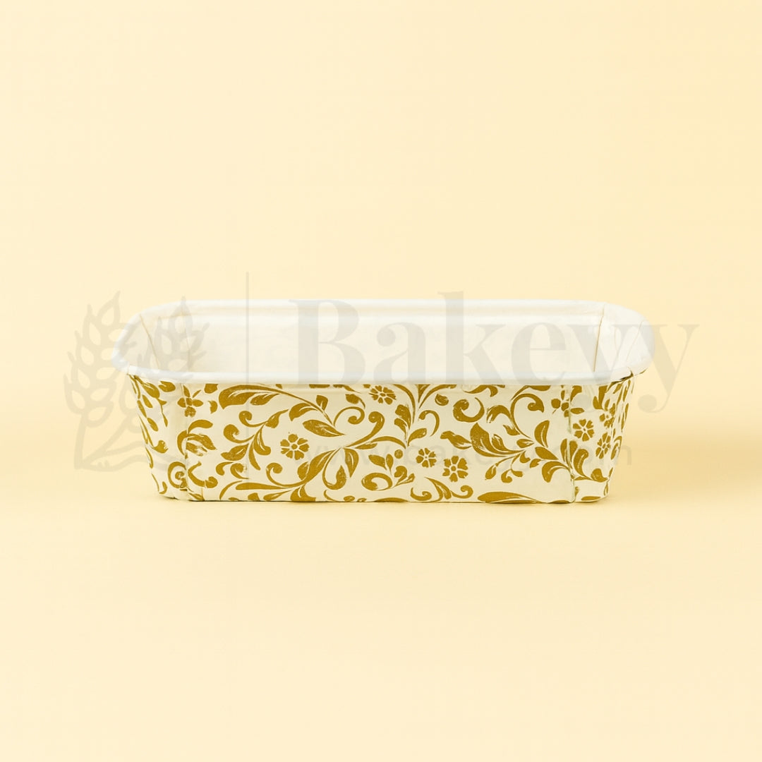 Clear plastic container with gold floral pattern on a beige background