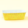 Yellow baking pan with floral patterns on a light yellow background