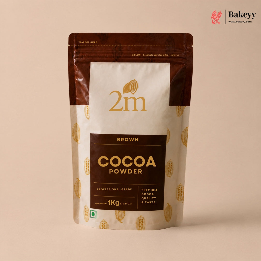 A 1kg stand-up pouch of 2m Brown Cocoa Powder, featuring a cream and dark brown design with gold cocoa bean illustrations, set against a solid beige background.