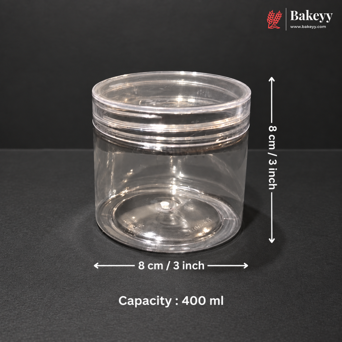 A clear plastic cylindrical storage jar with a screw-top lid, shown on a dark background with overlaid dimension arrows and text indicating 8 cm / 3 inch diameter and 400 ml capacity. The Bakeey logo appears in the top right corner.