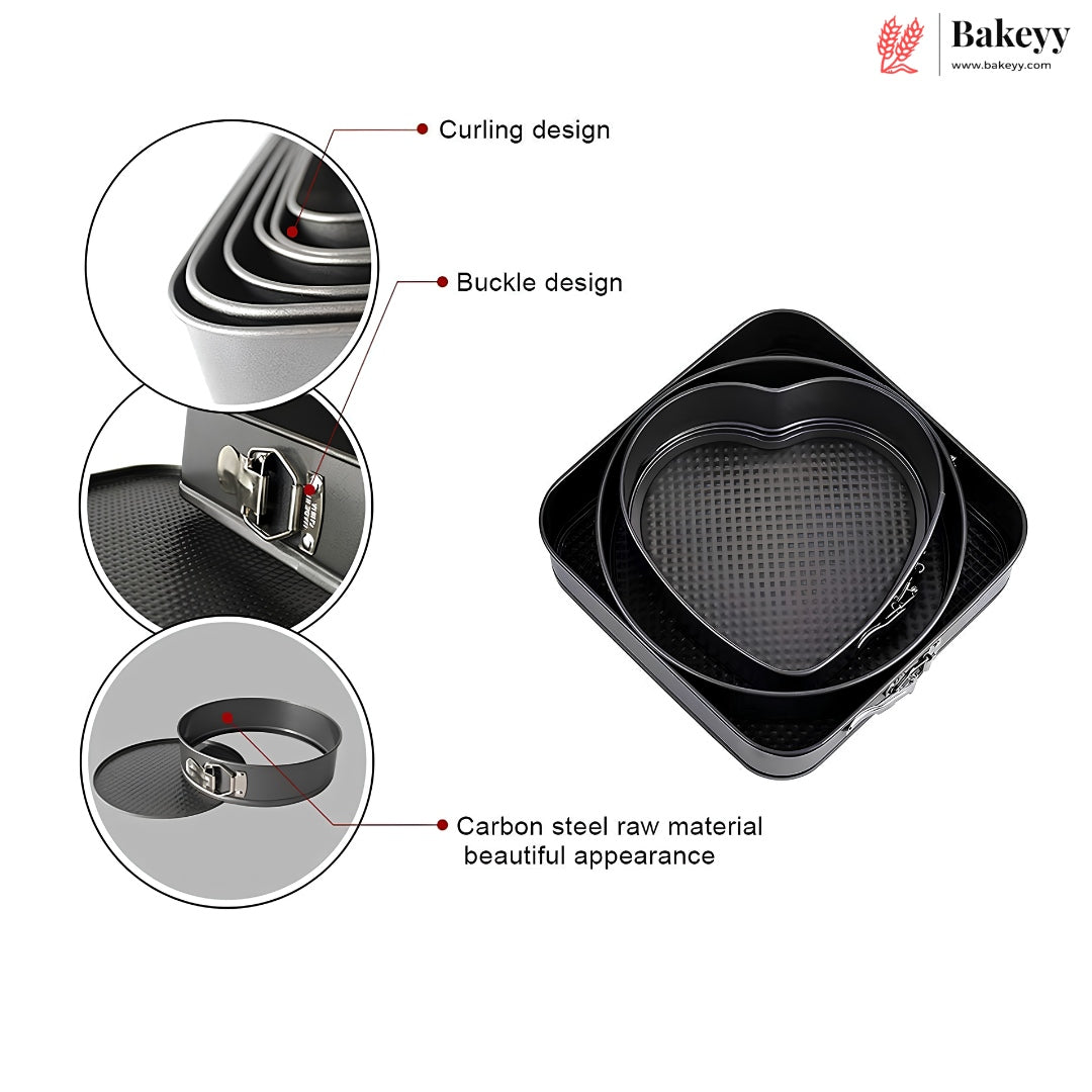 Black heart-shaped carbon steel springform cake pans shown with three circular detail callouts highlighting the curling design, buckle design, and raw material finish. The Bakeyy brand logo is visible in the top right corner.