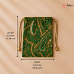 Green drawstring bag with gold paisley pattern and measurements on a beige background