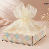 Decorative gift box with a sheer bow on a soft pink background, featuring dimensions.