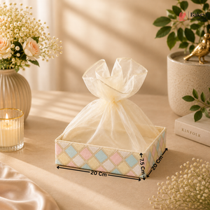 Decorative box with a sheer bow on a table with measurements indicated