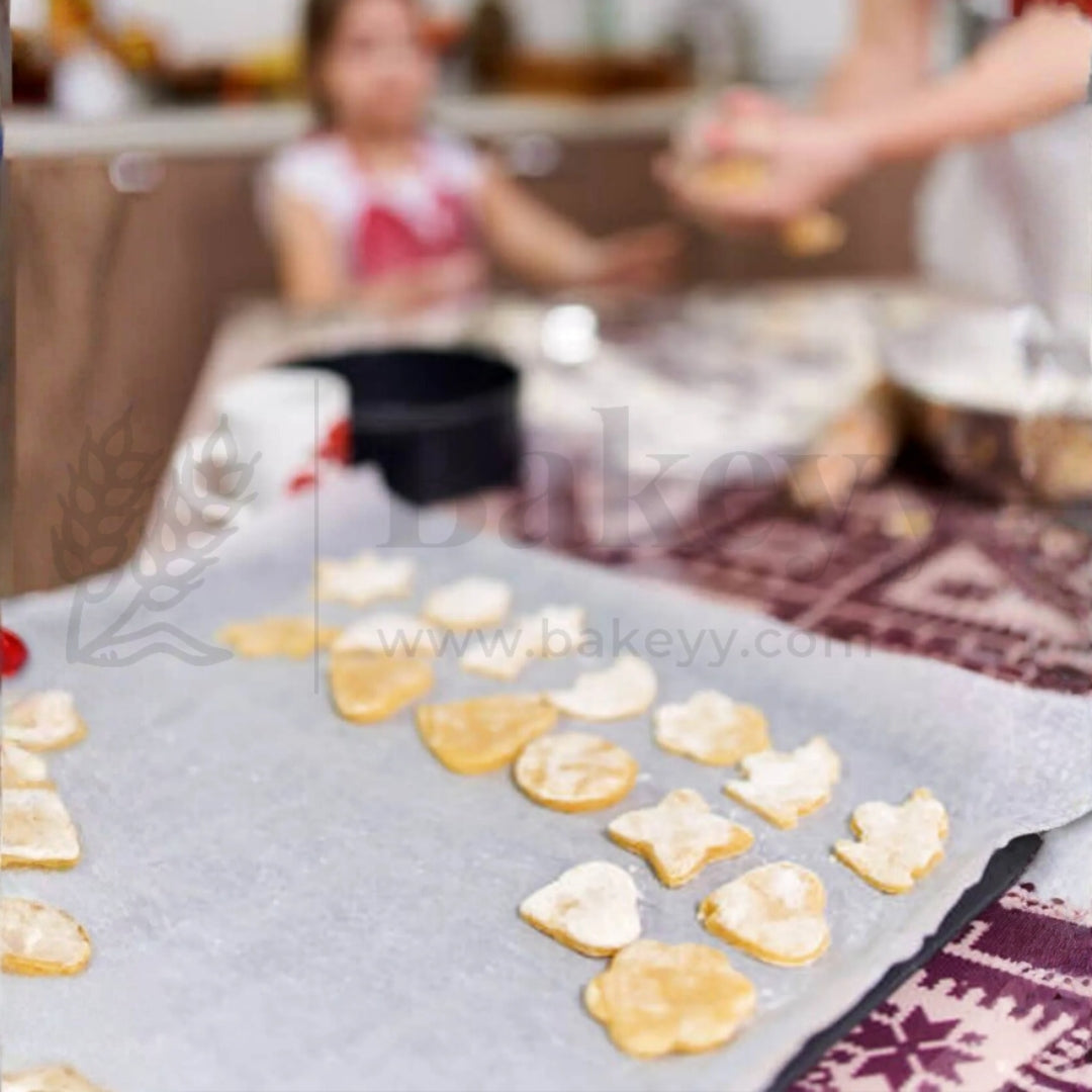Baked cookies on a baking sheet with a blurred kitchen background