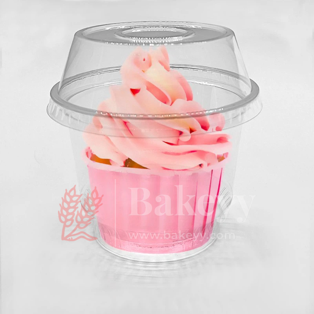 Pink cupcake in a clear plastic dome with 'Bakeyy' branding on a white background