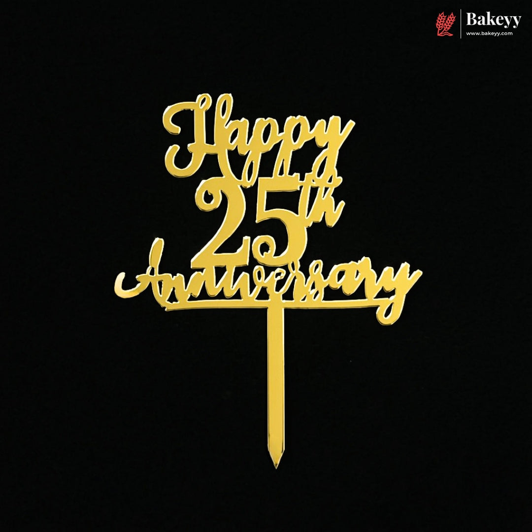 Gold metal cake topper with 'Happy 25th Anniversary' script on a black background, featuring a Bakeyy logo in the top right corner.