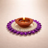 Clay diya lamp with flame, decorated with pearls and purple gemstones, Bakeyy.com