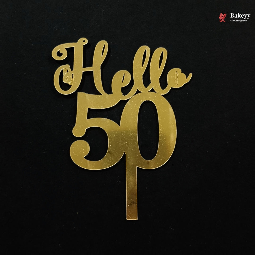Gold metallic 'Hello 50' cake topper on a black background, with a small Bakeey logo in the top right corner.