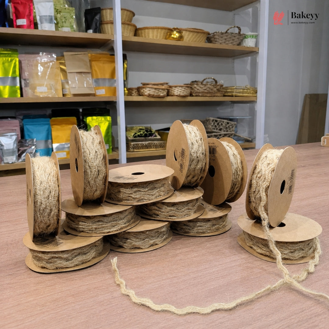Spools of twine on a wooden surface with shelves in the background