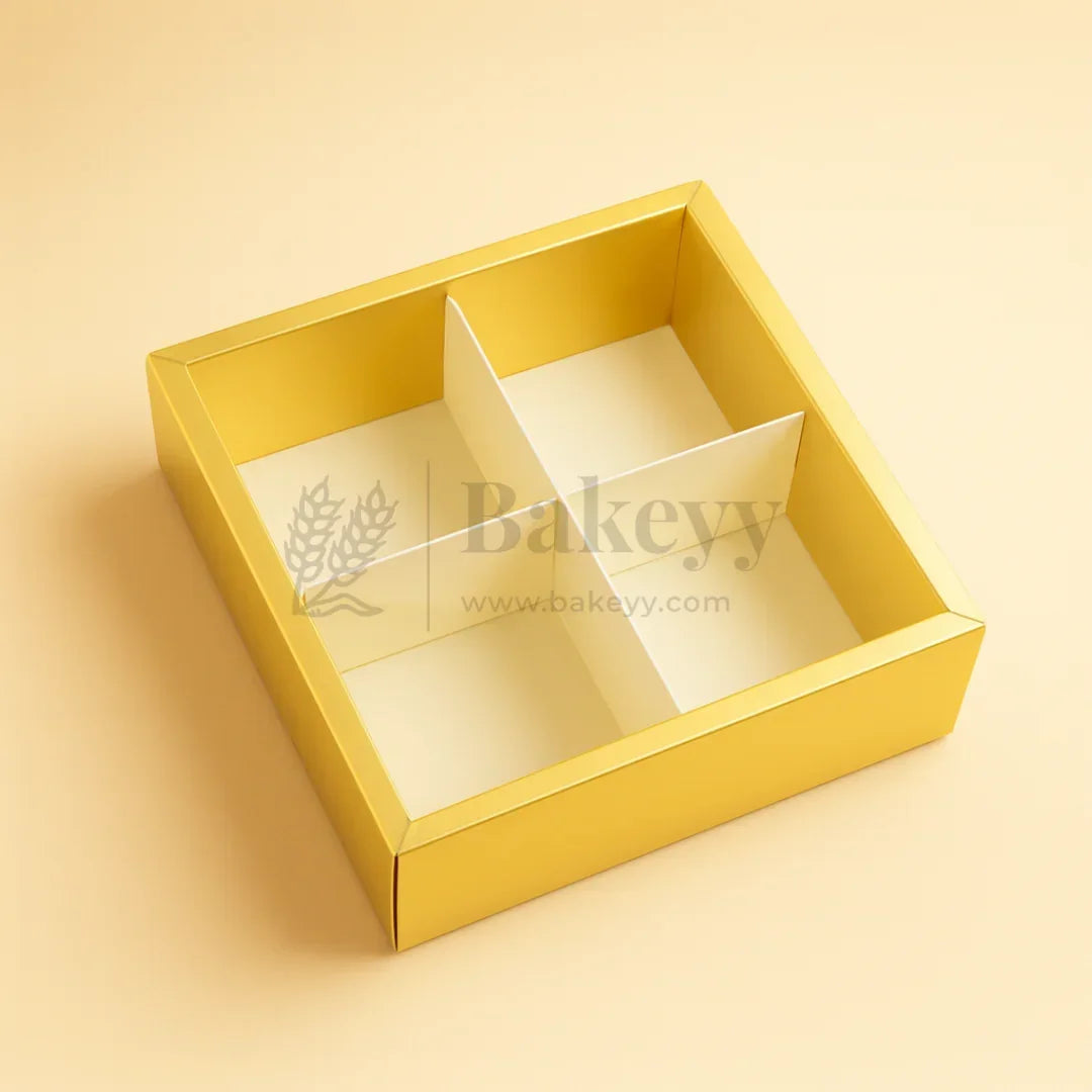 Gold bakery box with a clear lid on a beige background, featuring the brand 'Bakeyy'.