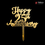 Gold-colored metal cake topper with 'Happy 25th Anniversary' script and number design, mounted on a pointed stake, shown against a solid black background. A Bakeyy brand logo is visible in the top right corner.