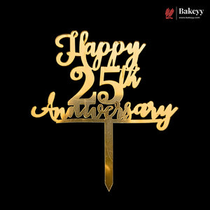Gold-colored metal cake topper with 'Happy 25th Anniversary' script and number design, mounted on a pointed stake, shown against a solid black background. A Bakeyy brand logo is visible in the top right corner.
