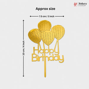 Gold-colored 'Happy Birthday' cake topper with balloon graphics, showing approximate dimensions of 10 cm in height and 7.5 cm in width, with a Bakeyy logo in the top right corner.