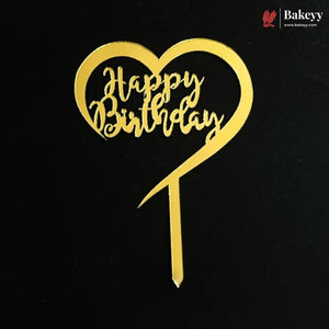 A gold heart-shaped cake topper with 'Happy Birthday' written in cursive script on a black background, with a Bakeey logo in the top right corner.