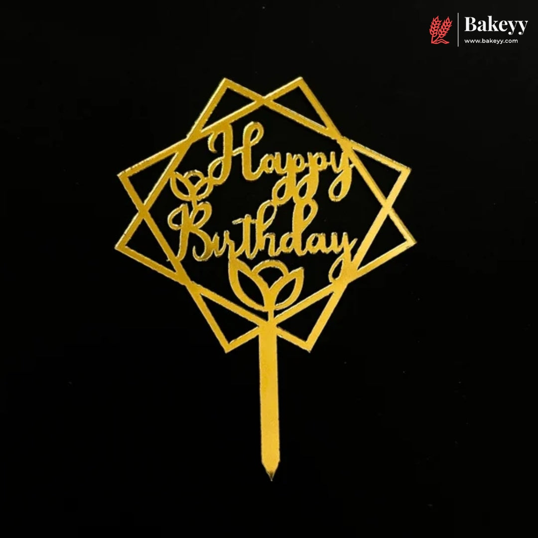 Gold metal Happy Birthday cake topper with geometric star and diamond frame design on a black background. A Bakeey brand logo is visible in the top right corner.