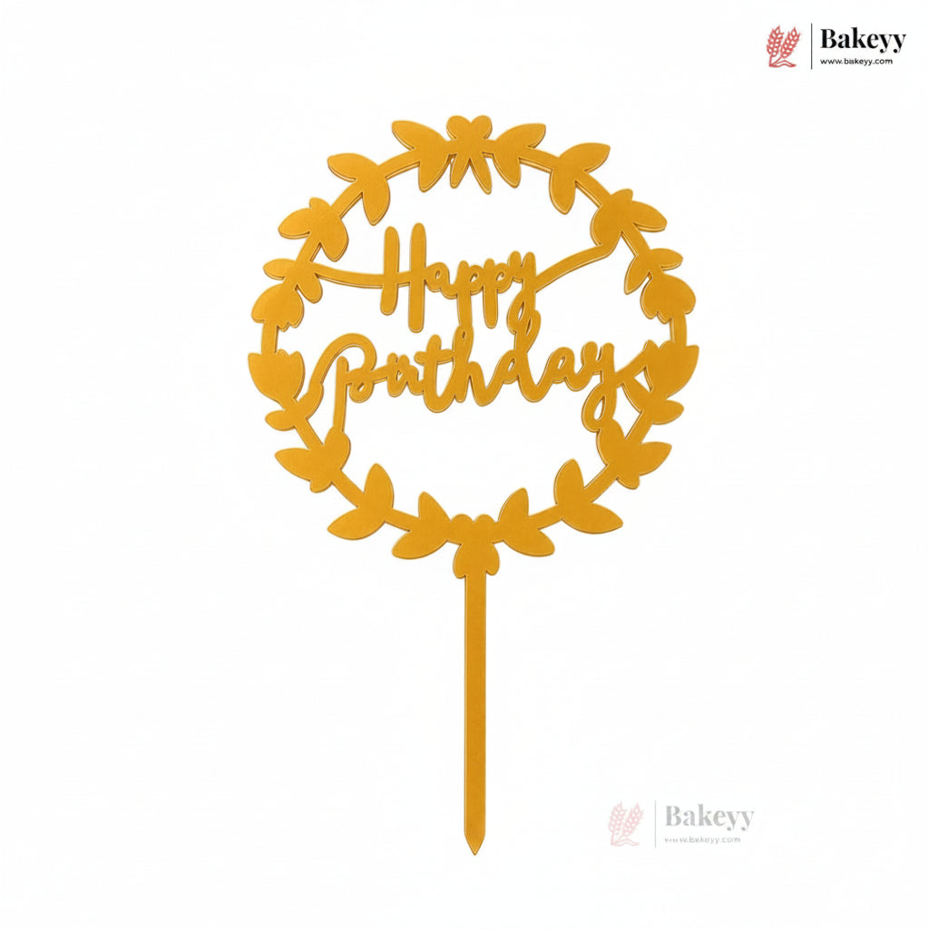 Yellow 'Happy Birthday' cake topper with leaf design on a white background, featuring Bakeyy branding.