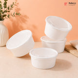Set of white disposable food containers on a beige surface with an orange background