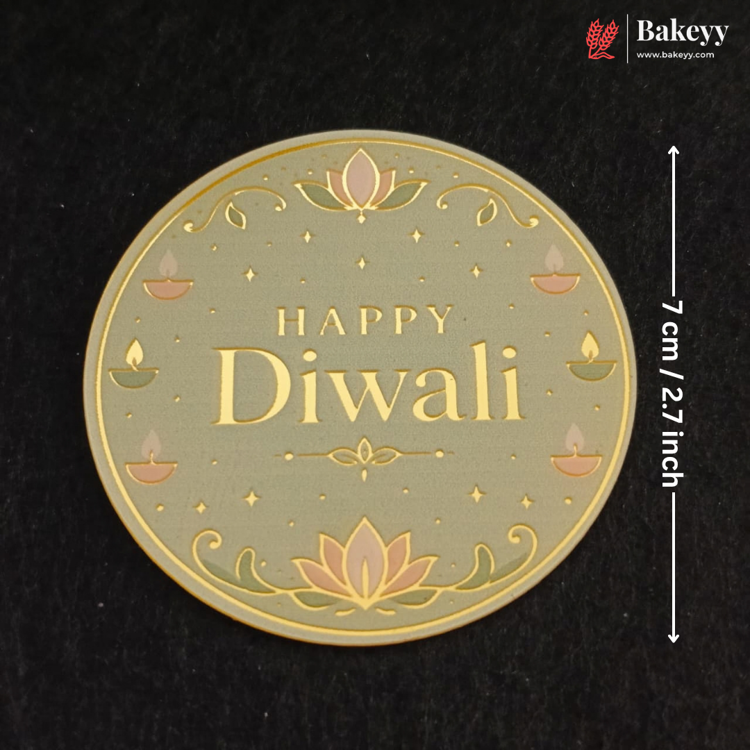 A round Diwali-themed decorative plaque or coaster with 'HAPPY Diwali' text, lotus flowers, and small diya illustrations on a black background. White measurement text at the right indicates 7 cm / 2.