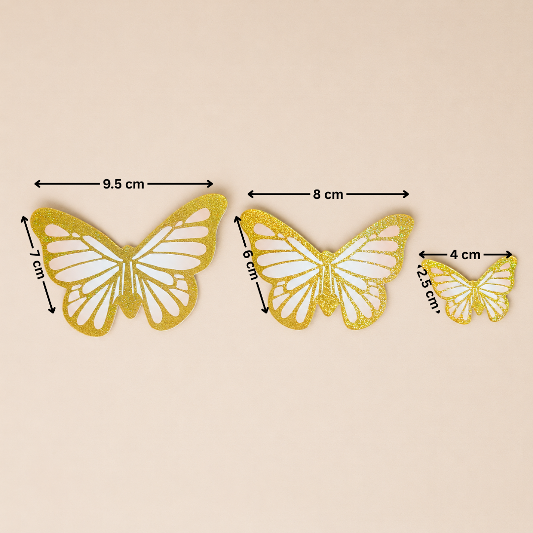 Three gold butterfly decorations with measurements on a beige background