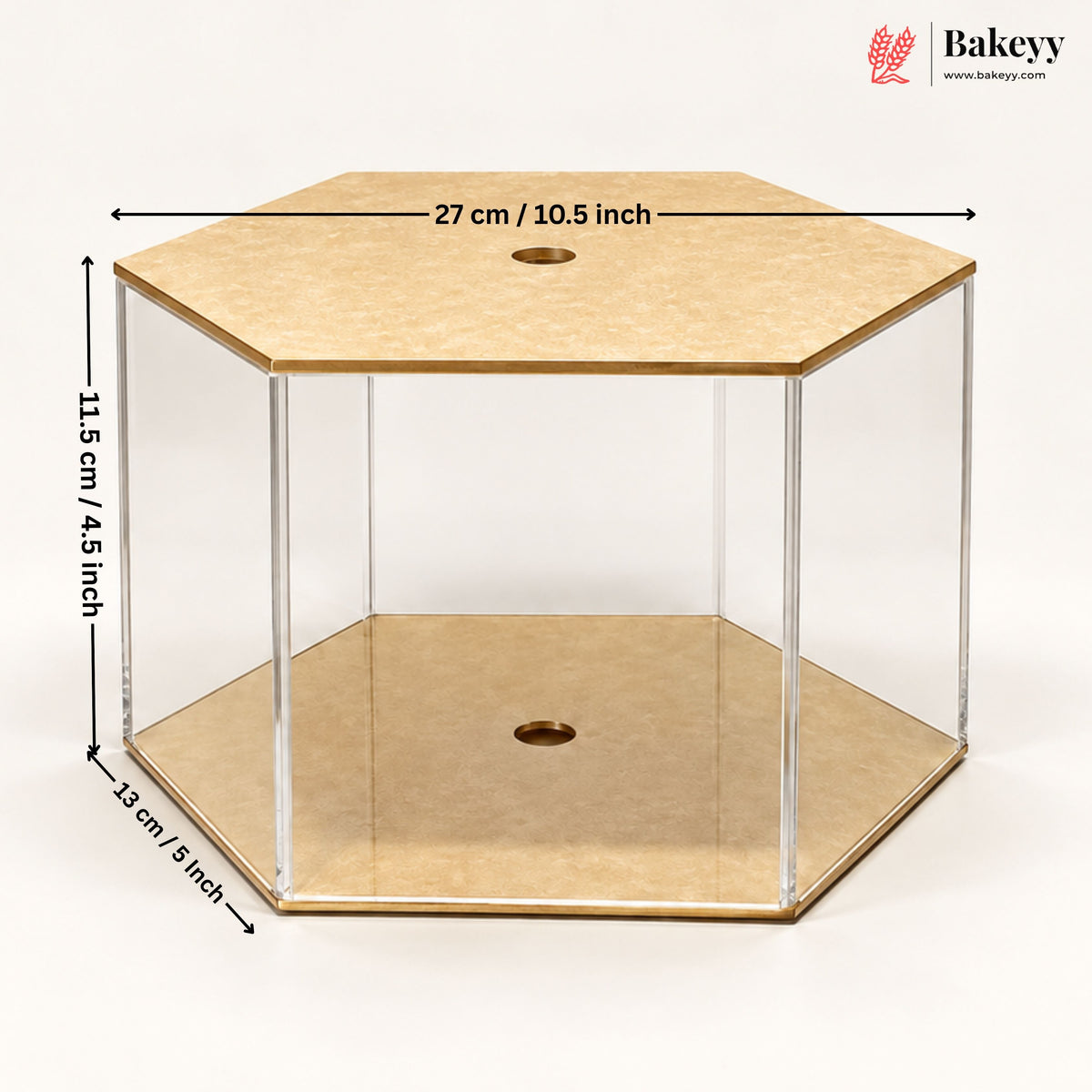 Hexagonal acrylic and wood display case with dimension labels showing 27 cm top, 11.5 cm height, and 12 cm base, on a white background.