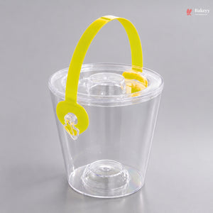 Clear plastic cup with a yellow handle on a gray background